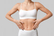 © Pixel-Shot - Young woman in underwear on light background, closeup. Plastic surgery concept