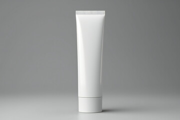 Wall Mural - Blank white cosmetic tube standing on grey background