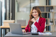 © amnaj - Young business woman working in modern office. Happy businesswoman with laptop computer in the office.