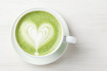 Close Up Of A Green Coffee Cup With A Heart Shaped Latte Art.