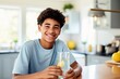 Happy young man indoors, holding a glass of water with lemon, radiating a healthy and confident lifestyle.
