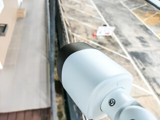 Installing CCTV cameras outside buildings and houses by attaching them to the wall.