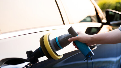 Woman hand polishing coating car