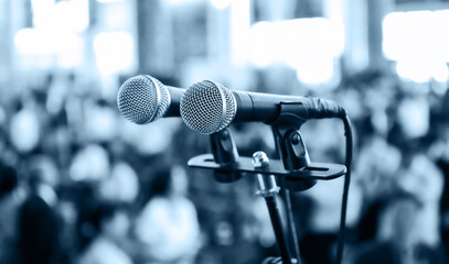 Wall Mural - Closeup microphone in auditorium with blurred people in the background