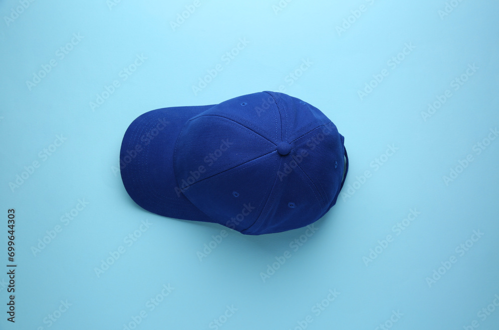 Stylish baseball cap on light blue background, top view Stock Photo ...