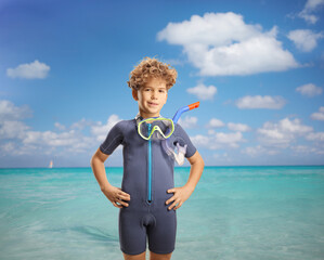 Wall Mural - Boy wearing a diving suit and mask in front of sea