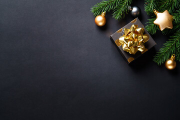 Poster - Christmas background with christmas tree, present box and holidays decorations. Black and gold christmas.