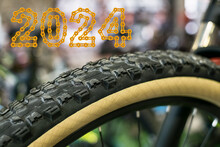 A Bicycle Wheel With Tire And 2024 Happy New Year Made From Golden Chain Links