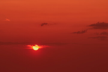 Wall Mural - The aerial view of the sunset over the ocean was breathtaking, with the sun casting a warm golden glow on the below.