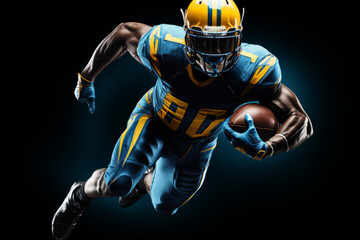 Portrait of American football player running with the ball. Muscular African American athlete in a blue and yellow uniform with an ovoid ball in a dynamic pose. Isolated on black background.