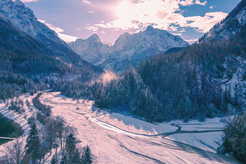 Wall Mural - Mountain landscape on a sunny day. View of Alps in Kranjska Gora. The tops of the mountains are covered with snow. Triglav national park. Slovenia, Europe Aerial view