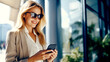 woman in sunglasses looking at her mobile phone, elegant look