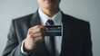 © Nawarit - Asian businessman holds a credit card mockup, credit card,wearing a suit, white background, isolated.
