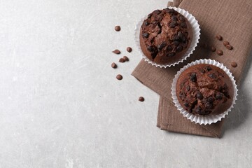 Wall Mural - Tasty chocolate muffins on grey table, top view. Space for text