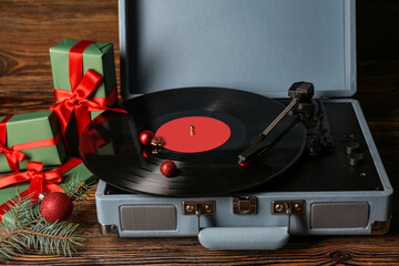 Poster - Vintage turntable with vinyl record and Christmas decorations on wooden background