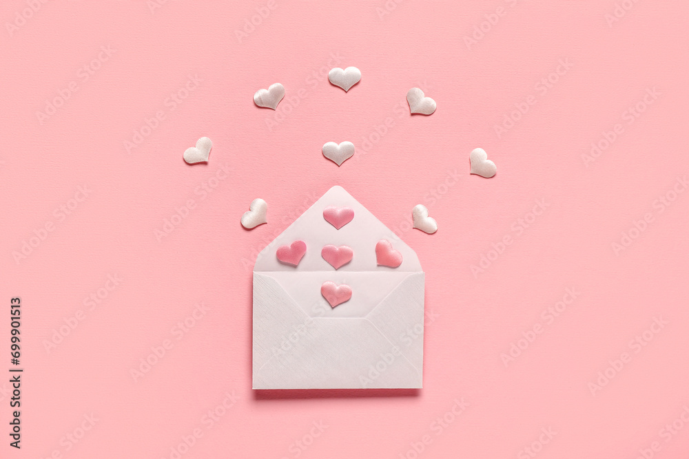 Composition with envelope and hearts on pink background. Valentine's Day celebration