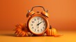 alarm clock on a orange background with pumpkins