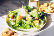 Classic caesar salad with lettuce, croutons and parmesan cheese