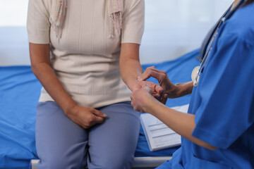 Wall Mural - Health check concept, Elderly Asian woman with grey hair, sitting and talking to young Asian nurse by appointment, sitting on medical bed.