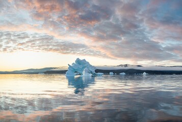 Wall Mural - Melting icebergs by the coast of Greenland, on a beautiful summer day - Melting of a iceberg and pouring water into the sea. Global warming
Arctic nature landscape, Summer day