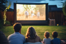 family watching movie together in backyard bokeh style background