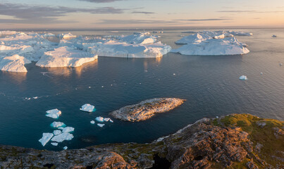 Wall Mural - Melting icebergs by the coast of Greenland, on a beautiful summer day - Melting of a iceberg and pouring water into the sea. Global warming
Arctic nature landscape, Summer day