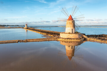 Wall Mural - Sunset at Windmills in the salt evoporation pond in Marsala, Sicily island, Italy
Trapani salt flats and old windmill in Sicily.
View in beautifull sunny day.