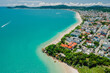 Holiday beach with resort town and turquoise ocean in Brazil. Aerial view