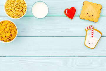 Wall Mural - Flat lay of food for kids - milk with cornflakes and biscuits, top view