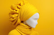 white mannequin wearing yellow headscarf