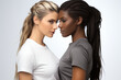 Two lesbian multinational women in t-shirts hugging on white background