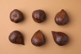 Delicious salak fruits on pale brown background, flat lay