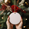 © Midnight Stock - Round Flat White Ceramic Holiday Ornament Christmas Mockup with Red Florals and Green Pine Branches