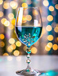 Celebration with a beautiful decorated wine glass with a turquoise drink.