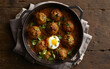 Capture the essence of Moroccan Meatball and Egg Tagine in a mouthwatering food photography shot