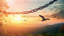 World Freedom Day Concept: Silhouette Of Bird Flying And Broken Chains At Autumn Mountain Sunset Background