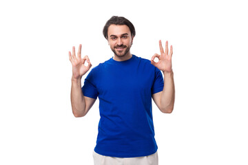 Wall Mural - young handsome european man with black hair and beard dressed in a blue t-shirt