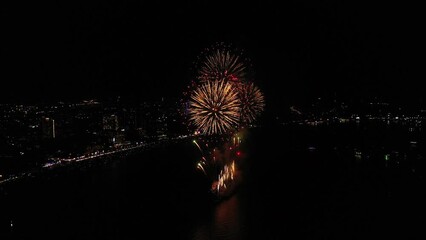 Wall Mural - Aerial top view of Celebration day. Skyline with fireworks light up sky over landmark skyscraper on the sea in Pattaya International Fireworks Festival, Thailand. Holidays, celebrating New year.	
