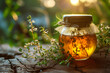 Close-Up of Wild Golden Herbal Honey in a Jar. Summer Delicious Sweetener with Thyme Herbs.