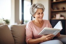 Image Of A Woman In Her Late Fifties Reading A Book On The Couch, Happy And Healthy Widescreen Format 