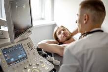 Ultrasound Specialist Examining Lower Abdomen Of Male Patient. The Concept Of Ultrasound Diagnostics And Men's Health