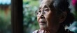 Asian elderly woman with Alzheimer's disease learns skills to rehabilitate practical motor abilities while dealing with dementia.