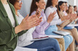 © Studio Romantic - Audience at a public business conference or seminar clapping hands after a good speech. Group of happy women sitting in a row, clapping their hands and smiling. Business concept