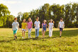 © Studio Romantic - Happy children walking in a line together outside and smiling in the park on holidays enjoying spending time in a summer camp. Full length portrait of a kids having a walk in nature.