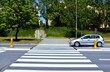 © Gold Picture - The car passes the pedestrian crossing with road from pedestrian refuge island