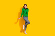 Full length body photo of cute lady wear green pullover touch cheek celebrate shopping season start isolated on yellow color background