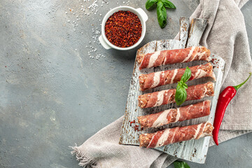 Wall Mural - pork mince with bacon wrapped sausages. copy space for text