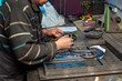 A metal craftsman works in his workshop.
