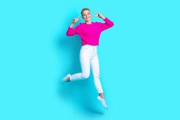 Wall Mural - Full length portrait of excited carefree person jump demonstrate v-sign near eyes isolated on turquoise color background