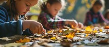 Children Engage In A Hands-on Autumn Art Workshop, Crafting With Glue, Scissors, And Natural Materials, Promoting Creativity And Outdoor Education.